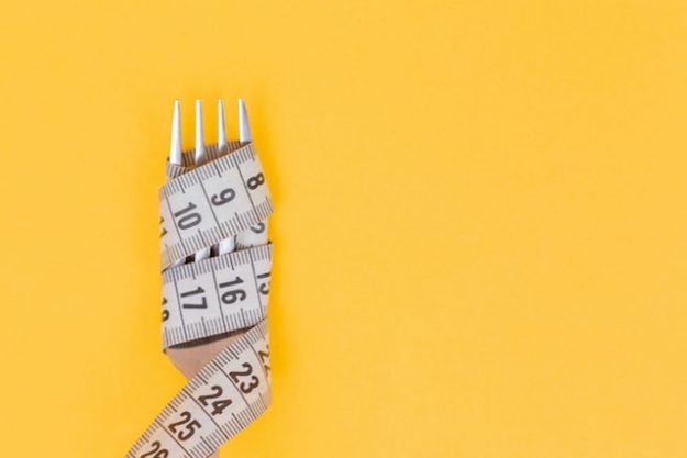 Measuring tape wrapped tight around a fork
