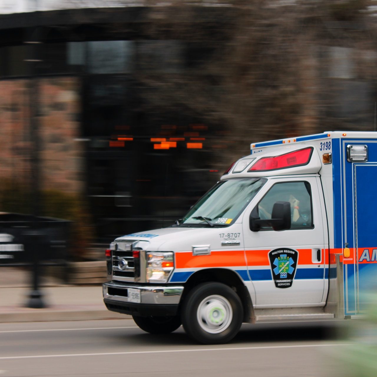 An ambulance rushes down a city street