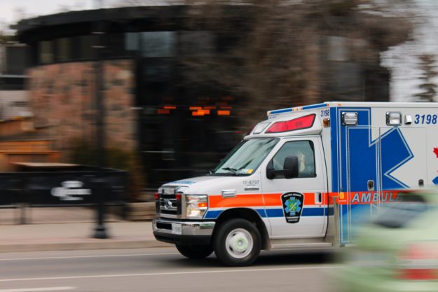 An ambulance rushes down a city street
