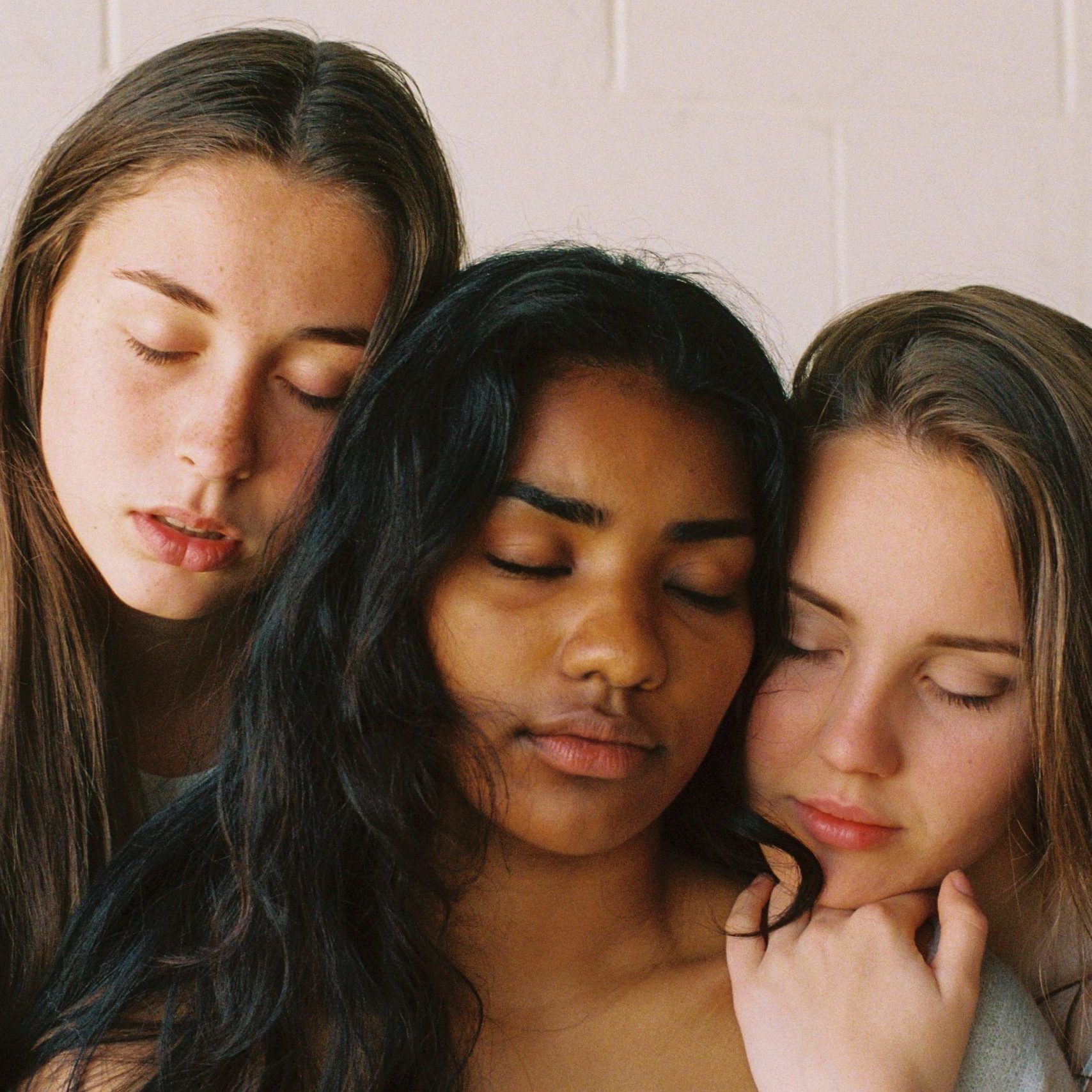 three people sitting beside each other