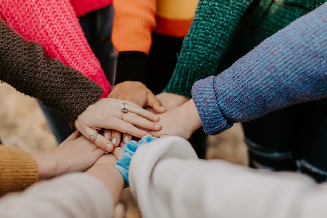 fall-newsletter-2023 Hands together in a huddle.