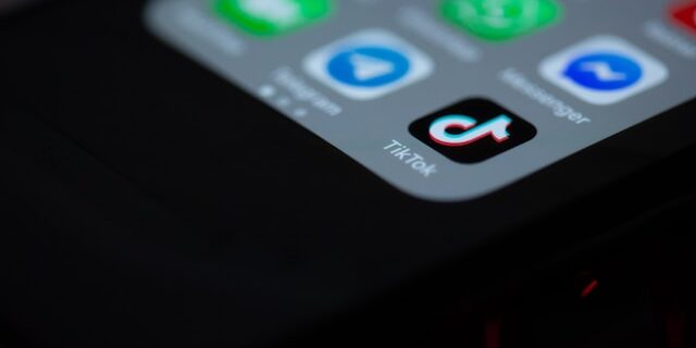 An iPhone home screen with the tiktok app in deep focus.