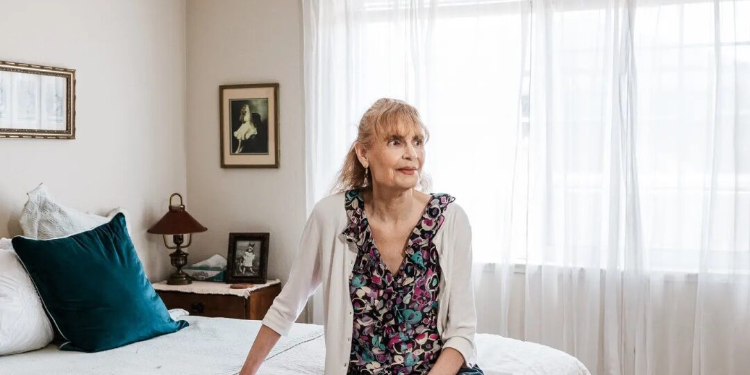 EDRC Founder Janice Bremis sits contemplatively on a bed.